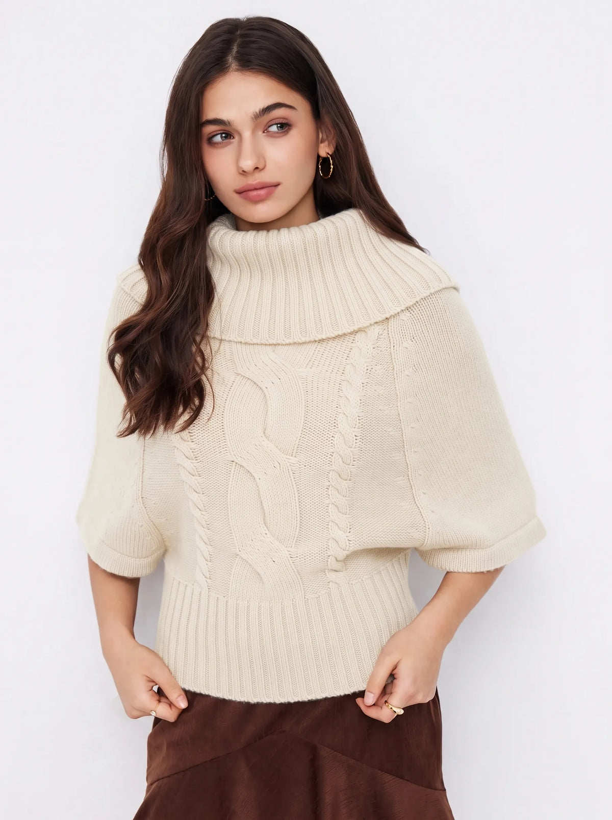 Capucine cable-knit roll-neck sweater in white, worn